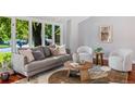 Bright and airy living room with a large window, comfortable seating, and modern decor at 9951 Winona St, Westminster, CO 80031