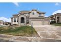 Charming two-story home with a three-car garage, landscaped yard and neutral-tone exterior at 6911 Chestnut Ct, Parker, CO 80134