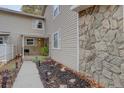 Townhouse exterior with stone accents and walkway leading to the entrance at 2752 S Heather Gardens Way, Aurora, CO 80014