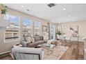 Inviting living room area, bright windows, hardwood floors, and adjacent dining space at 21210 E Radcliff Pl, Aurora, CO 80015