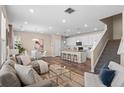 Open-concept living space with a modern kitchen, dining area, and comfortable seating, perfect for gatherings at 21210 E Radcliff Pl, Aurora, CO 80015