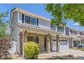 Charming two-story home featuring stone accents, blue shutters, and a well-manicured front yard at 18807 E 51St Pl, Denver, CO 80249