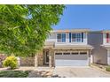 Charming two-story home featuring stone accents, blue shutters, and a well-manicured front yard at 18807 E 51St Pl, Denver, CO 80249