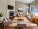 Staged living room featuring high ceilings, fireplace, and hardwood floors at 1220 W 170Th Ave, Broomfield, CO 80023