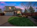 Charming two-story home with a brick driveway, well-manicured lawn, and a blend of brick and siding facade at 20000 Mitchell Pl # 9, Denver, CO 80249