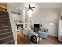 Spacious living room featuring a fireplace, high ceilings, and staircase to an open loft space at 20000 Mitchell Pl # 9, Denver, CO 80249