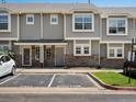 Charming townhome exterior with gray siding, stone accents, and visitor parking during the day at 9024 Gale Blvd # 3, Thornton, CO 80260