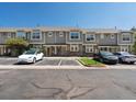 Townhome exterior with gray siding, stone accents, visitor parking, and well-maintained landscaping at 9024 Gale Blvd # 3, Thornton, CO 80260