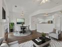 Bright living room featuring a fireplace, dining area, and seamless flow into the kitchen at 9024 Gale Blvd # 3, Thornton, CO 80260