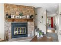 Living room boasts stone fireplace, stairs to the second floor and neutral carpeting for a warm and inviting space at 10715 Foxwood Ct, Parker, CO 80138