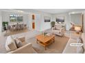 Virtually staged living room with seating area and dining space at 4418 E Caley Ln, Centennial, CO 80121