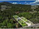 Gorgeous aerial view showing the property's boundaries, multiple cabins, and proximity to the highway at 63 Sillasen Ln, Golden, CO 80403