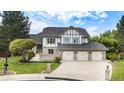 Beautiful two-story home with manicured lawn and a three-car garage at 16301 E Ida Ave, Centennial, CO 80015