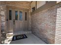 Beautifully designed front door features sidelights and a decorative wreath doormat at 16301 E Ida Ave, Centennial, CO 80015