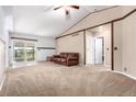 Bright living room with neutral carpet and sliding glass doors leading to outdoor patio at 1015 S Fulton Ave, Fort Lupton, CO 80621