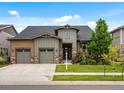 Charming home with a two-car garage, complemented by lush landscaping and a warm, inviting exterior at 2113 Fountain Cir, Erie, CO 80516