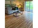 Bright living room featuring a sliding glass door with outside views and comfortable seating at 13626 E Bates Ave # 110, Aurora, CO 80014