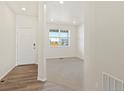 Inviting foyer featuring wood floors transitioning to carpet in adjacent room at 8898 Salida St, Commerce City, CO 80022