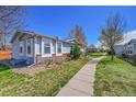 Charming single-story home with blue siding, brick accents, and a well-maintained lawn at 6631 E 78Th Avenue Ave, Commerce City, CO 80022