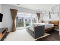 Bright main bedroom with large window, ski lift wall art and comfortable seating area at 2550 Lawrence St # Rb306, Denver, CO 80205