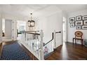 Sun-drenched hallway with hardwood floors and a custom runner leads into several rooms at 6375 E Tufts Ave, Englewood, CO 80111
