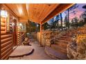 Inviting entryway with stone steps leading to a charming log cabin home at 608 Patty Dr, Evergreen, CO 80439