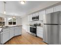 Modern kitchen with stainless steel appliances, granite countertops, and ample cabinet space at 16928 Dandelion Way, Parker, CO 80134