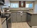 Cozy kitchen featuring gray cabinets, stainless steel appliances and a sink under the window at 7933 Countryside Dr # 120, Niwot, CO 80503