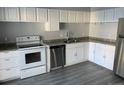 Modern kitchen featuring white cabinets, granite countertops, and stainless steel appliances at 2678 S Xanadu Way # C, Aurora, CO 80014