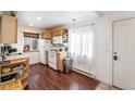 Bright kitchen features wood cabinets, a white refrigerator, and hardwood floors at 100 Now Colorado Ct # D1, Breckenridge, CO 80424