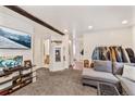 Open living room with large TV and view of the bathroom and laundry room at 100 Now Colorado Ct # D1, Breckenridge, CO 80424
