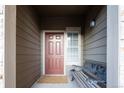 Inviting entryway with bench, front door and charming details at 7432 S Quail Cir # 1818, Littleton, CO 80127