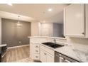 Bright kitchen with marble countertops, stainless steel appliances, and a double sink at 7440 S Blackhawk St # 4-104, Englewood, CO 80112
