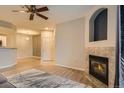 Living room view showcasing fireplace, access to other rooms, and stylish decor at 7440 S Blackhawk St # 4-104, Englewood, CO 80112