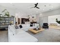 Bright, open-concept living room with stylish decor, a modern ceiling fan, and seamless flow to the kitchen at 1711 Boulder St, Denver, CO 80211