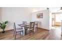 Bright dining area featuring modern wood floors, a stylish table set for four, and neutral decor at 10956 Osprey Ct, Parker, CO 80134