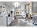 Bright kitchen with modern grey cabinets, stainless steel appliances, and ample counter space for cooking at 13742 W 67Th Pl, Arvada, CO 80004