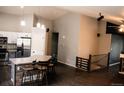 Open-concept living room adjacent to kitchen features hardwood floors and vaulted ceilings for a spacious feel at 11384 Oakland Dr, Commerce City, CO 80640