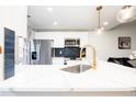 Modern kitchen featuring stainless steel appliances, white cabinets, and a gold faucet at 1543 S Ouray Cir # B, Aurora, CO 80017