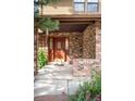 Inviting front door with brick surround and visible house number, adding a touch of curb appeal to the home at 7603 W Coal Mine Pl, Littleton, CO 80128