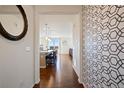 Entryway featuring hardwood floors and stylish wallpaper leading to an open concept living space at 10554 Casper Pt, Parker, CO 80134