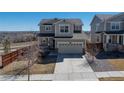 Inviting two-story home boasts a two-car garage, covered porch, and manicured front yard at 10554 Casper Pt, Parker, CO 80134