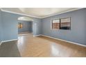 Inviting living room featuring hardwood floors and an arched doorway, creating a cozy and open atmosphere at 2280 S Decatur St, Denver, CO 80219