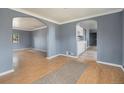 Inviting living room featuring hardwood floors and an arched doorway, creating a cozy and open atmosphere at 2280 S Decatur St, Denver, CO 80219