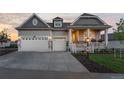 Two-car garage showcasing curb appeal and a spacious driveway at 15750 Willow Way, Brighton, CO 80602