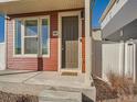 Inviting front entrance with a well-maintained door, a 'Welcome Home' mat, and neat gravel landscaping at 4987 N Walden Way, Denver, CO 80249