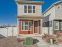 Two-story home featuring light siding, a front porch, and a well-maintained yard with gravel and steps leading to the entrance at 4987 N Walden Way, Denver, CO 80249