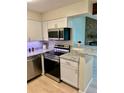 Updated kitchen with stainless steel appliances and granite countertops provides a modern cooking space at 10251 W 44Th Ave # 3-204, Wheat Ridge, CO 80033