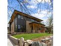 Contemporary home boasts a blend of dark and light exteriors and a lush lawn at 1100 S Elizabeth St, Denver, CO 80210