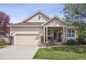 Charming single-Gathering home featuring a well-manicured lawn, two-car garage, and inviting covered front porch at 1844 S Jay Way, Lakewood, CO 80232